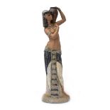 A Lladro figure of imposing proportions modelled as a female water carrier wearing Egyptian dress,