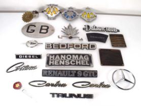A group of car badges including Cortina, Hanomag, The Royal Dutch Touring Club ANWB, Renault 9 GTC