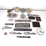 A group of car badges including Cortina, Hanomag, The Royal Dutch Touring Club ANWB, Renault 9 GTC