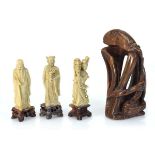 A group of three soapstone figures, h. 15 cm, together with an African Tribal hardstone carving (4)