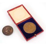 A cased 1902 Edward VII Coronation Medal together with a Services medallion from the Exhibition of