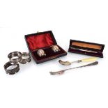 A mixed group of silver comprising a pair of ovoid peppers, a mother of pearl pen, a scuttle spoon