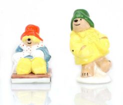 Two Coalport figures modelled as Paddington and Aunt Lucy, max h. 8 cm (2)