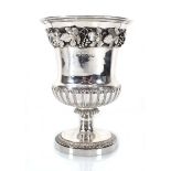 A George IV silver vase of urn shaped form relief decorated with fruiting vines, maker WE, London