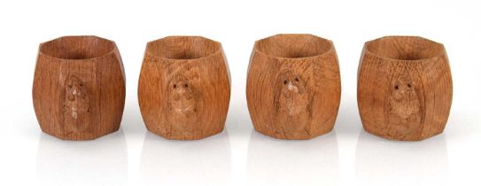 A set of four Robert 'Mouseman' Thompson carved oak napkin rings bearing the signature mice