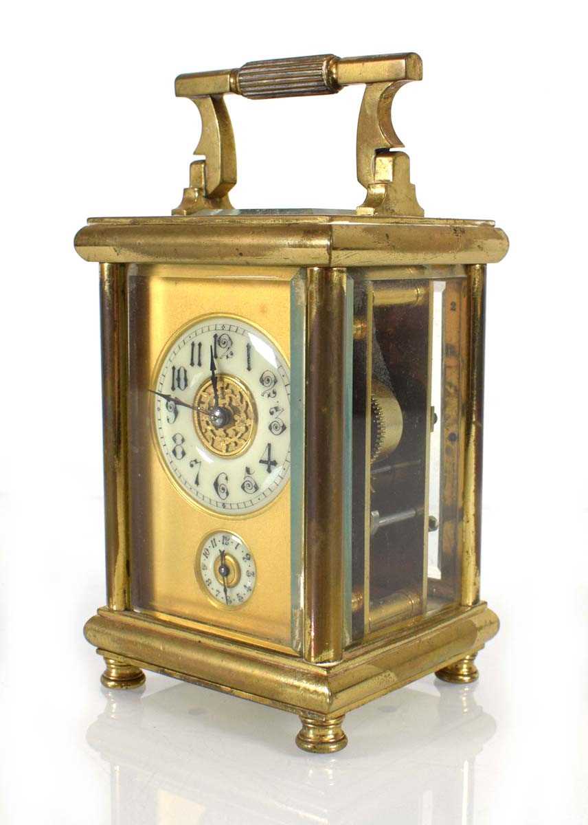 A French carriage clock in a brass and five-glass case with an enamelled dial, Arabic numerals and a