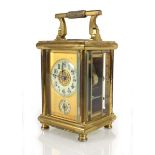 A French carriage clock in a brass and five-glass case with an enamelled dial, Arabic numerals and a