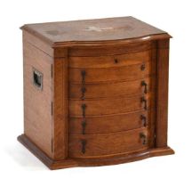 An early 20th century oak and strung canteen of Wellington-form with a bow front, lift lid and