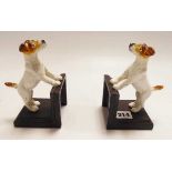 A pair of hand painted cast metal book ends in the form of terrier dogs.