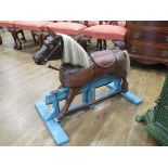 A small oak and leather child's rocking horse on a teal painted base, l. 81 cm (af)In need of