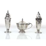 An early 20th century silver three piece cruet set of canted vase shaped form, Viners, Sheffield