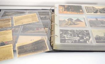 An album containing approximately three hundred and forty postcards including several pages relating