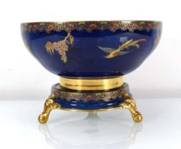 A Carltonware lustreware fruit bowl and stand, gilt decorated in coloured enamels with exotic