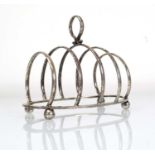 A silver four slice toast rack of arched form on bun feet, George Unite, Birmingham 1924, h. 8.5 cm,