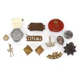 A small group of cap badges, buttons etc. including a buckle dated 1927