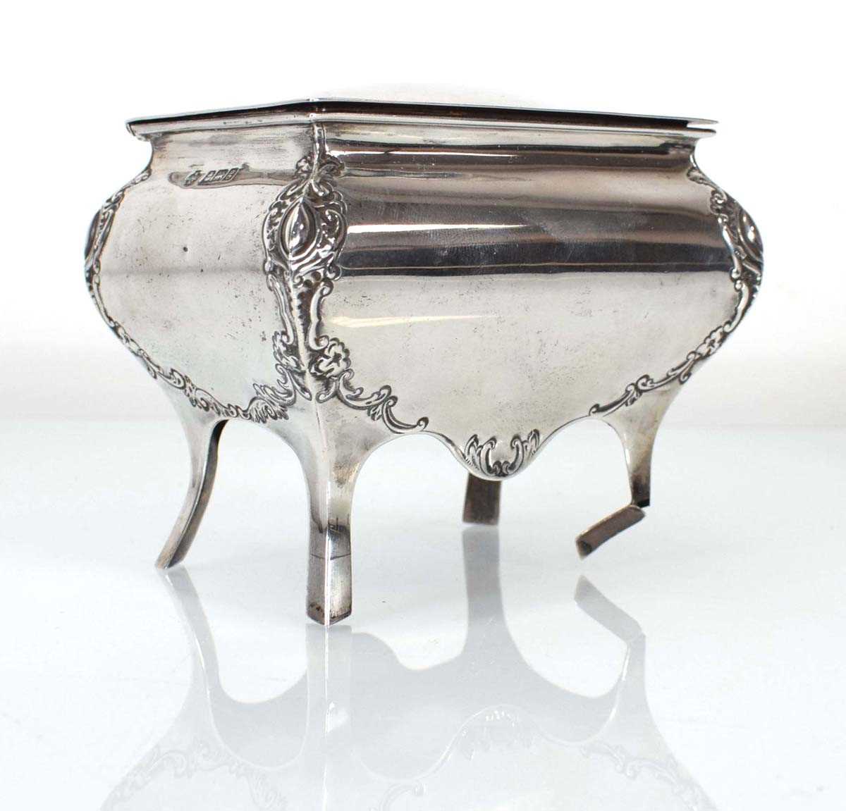 An Edwardian silver trinket box of sarcophagus form raised on four outswept legs, William Hutton &