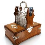 A Victorian oak two-bottle games tantalus with silver-plated mounts, stamped Betjemann's, w. 40