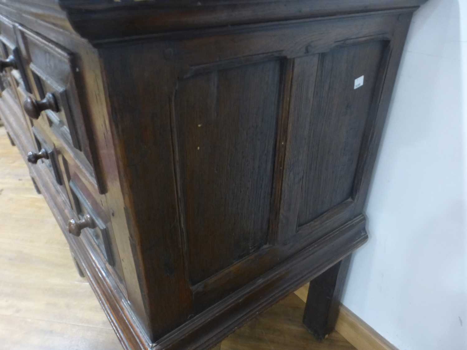 An oak dresser base incorporating 17th century elements, the central carved panelled door flanked by - Bild 23 aus 24