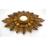 A 1920/30's giltwood 'sunburst' or 'starburst' wall mirror, total 39 x 54 cmThe glass on the