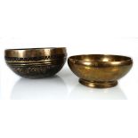 A Tibetan brass 'singing bowl', d. 16 cm, together with a Chinese example (2)Smaller bowl d. 13