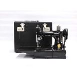 A cased Singer 222K featherweight free-arm sewing machineHas foot pedal, spools, oil, needle