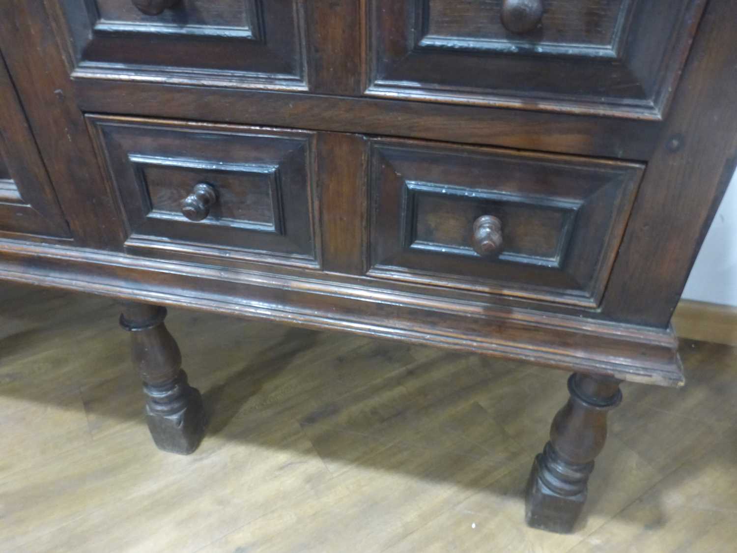 An oak dresser base incorporating 17th century elements, the central carved panelled door flanked by - Bild 4 aus 24