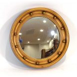 A Regency-style giltwood cavetto convex wall mirror, d. 43 cm