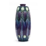 A Minton Secessionist vase decorated with green stylised flowers on a purple ground, ink mark and