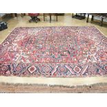 A Turkish carpet, the red ground with floral motifs, 350 x 267 cm