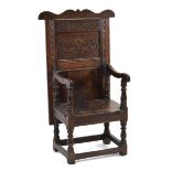 A 17th century and later carved oak and panelled Wainscott chair, circa 1650, the back mounted on