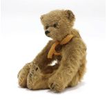 A small Steiff fully jointed bear with black boot button eyes, plain button to ear, l. 19 cm (af)