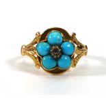 An early 20th century yellow metal flowerhead ring set small diamond and five turquoise within a