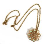 A gold plated curblink necklace suspending an (?)American yellow metal openwork pendant/brooch of