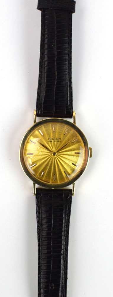 A gentleman's 14ct yellow gold wristwatch by Gruen, the circular sunburst engraved dial with baton
