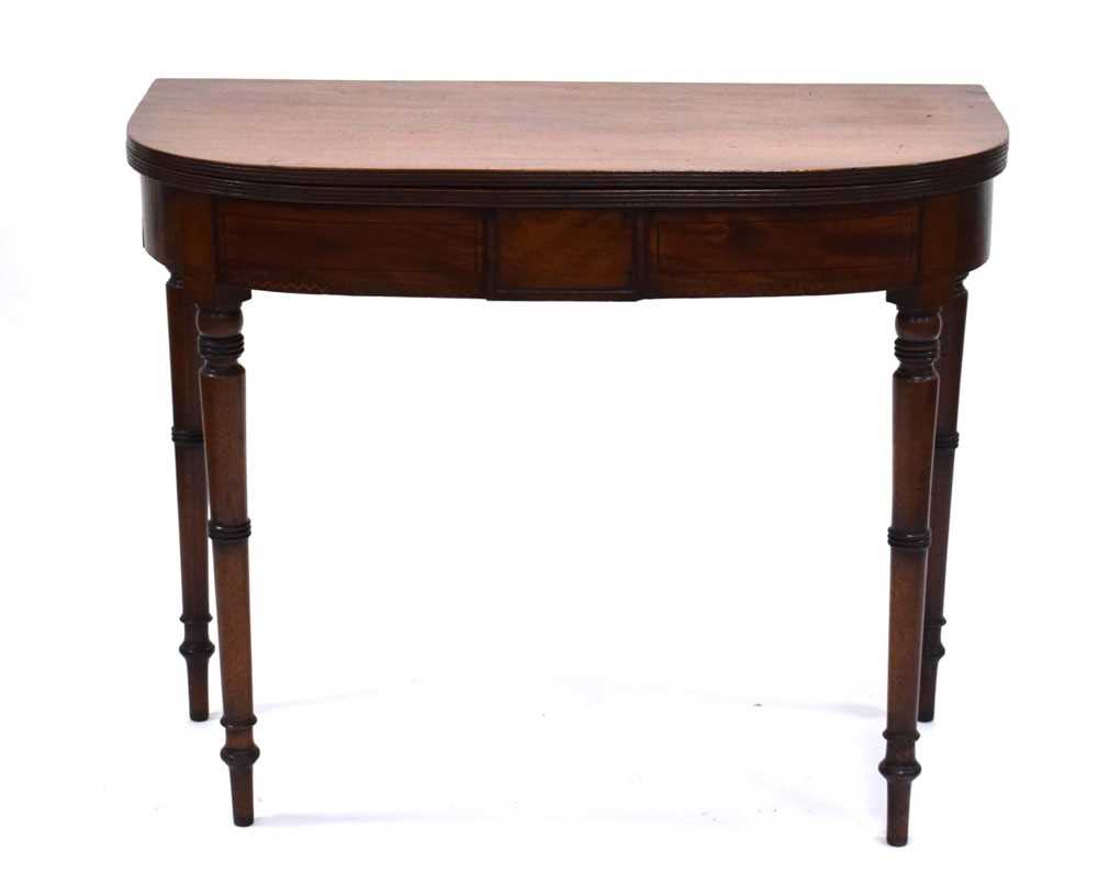 An early 19th century mahogany folding tea table, the frieze with marquetry banding, on turned - Image 2 of 5