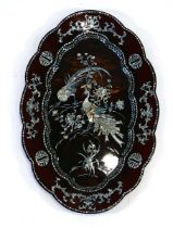 A Japanese black lacquered tray decorated with mother-of-pearl motifs and birds, on a faux
