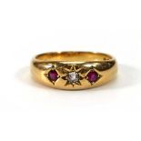 An Edwardian 18ct yellow gold gypsy ring set diamond and two rubies in recessed star settings,