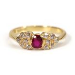 An 18ct yellow gold ring set oval ruby and twelve small diamonds,ring size T 1/2,3.8 gmsWell worn