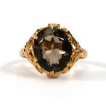 A Chinese yellow metal ring set smoky quartz in a leafy setting,ring size O,4 gms