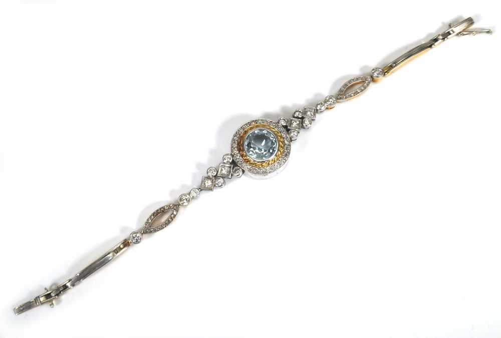 A yellow and white metal highlighted cocktail bracelet set centrally with a brilliant cut aquamarine