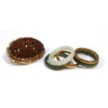 A set of five Chinese export yellow metal and green hardstone stacking rings, ring size J and a