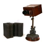 A Negretti & Zambra stereoscopic table viewer, the mahogany box with twin eye shields and ivory