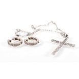 A 9ct white gold chainlink necklace suspending an 18ct white gold cross pendant set small