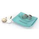 A pair of Tiffany & Co. oval silver cufflink's, with pouch and a similar pair of circular silver