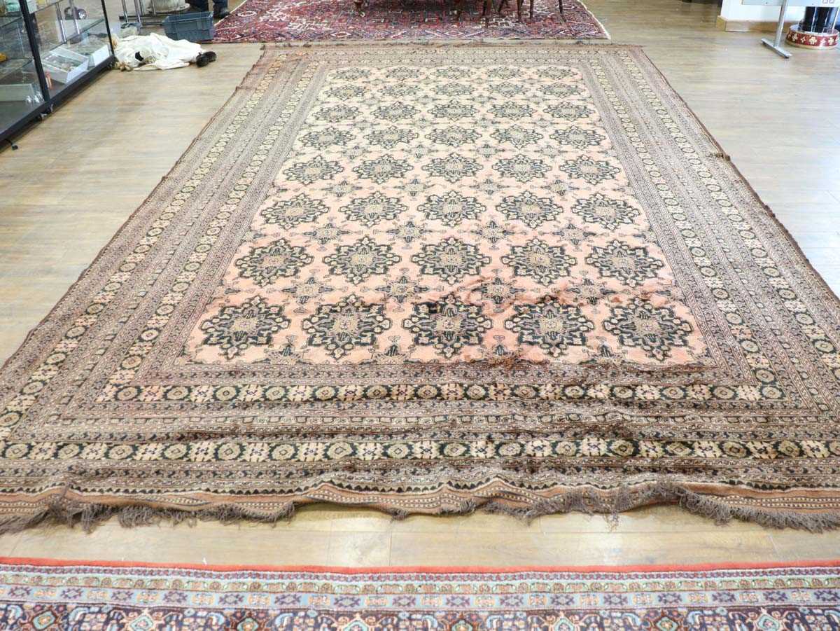 An Afghan carpet, circa 1940/50's, woven in the stylised Turkmenistan style, the red ground with