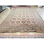 An Afghan carpet, circa 1940/50's, woven in the stylised Turkmenistan style, the red ground with
