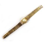 A ladies 9ct yellow gold wristwatch by Tissot, the tonneau dial with baton numerals on an