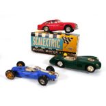 A Scalextric C68 Aston Martin DB4 GT, boxed, a C57 Aston Martin and a C66 Cooper-Austin, together