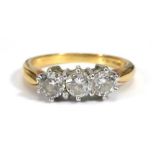 An 18ct yellow gold ring set three brilliant cut diamonds in an inline setting, stones approx. 0.