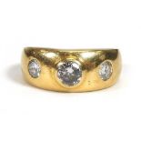 An 18ct yellow gold ring set three diamonds in recessed settings,central stone approx. 0.25 carats,